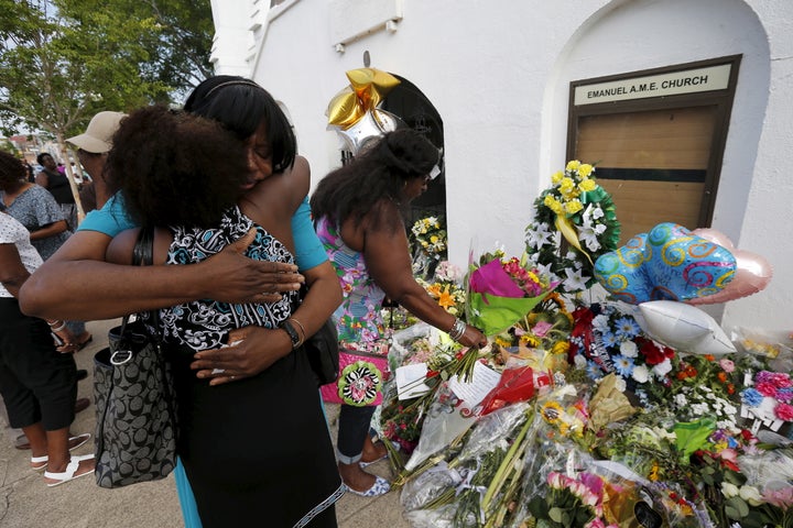 Kumba Mboma and Lucinda Maywood hug at a makeshift memorial outside the Emanuel African Methodist Episcopal Church in Charles