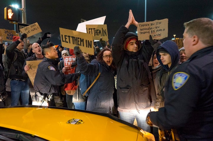 Protesters temporarily block an intersection at JFK International Airport in New York on Saturday. A strike by taxi drivers to protest Trump’s executive order on immigration led to a backlash against Uber, which kept providing rides.