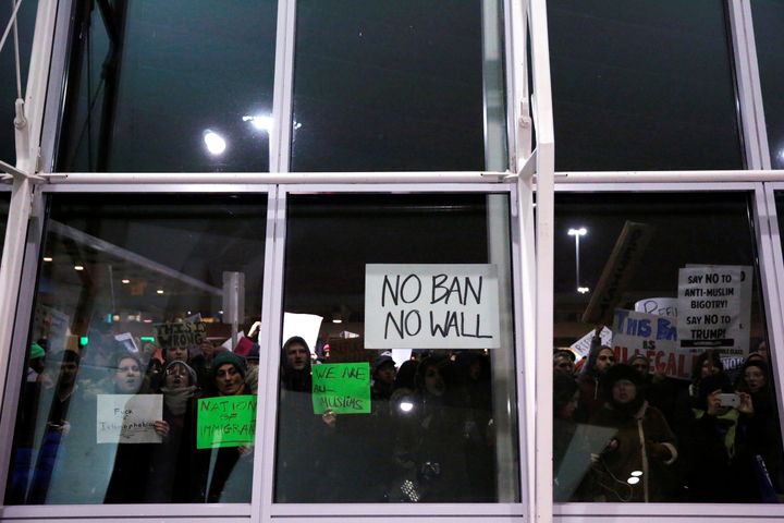Protesters yell through the windows of Terminal 4 during a protest against Donald Trump's travel ban at John F. Kennedy International Airport in Queens, New York, U.S., January 28, 2017.
