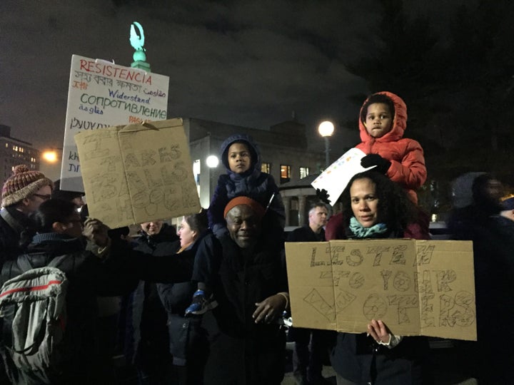 Casmir Andoh (left) and his wife Tiffiny Williams (right) with their two sons attend the Tuesday's protest.