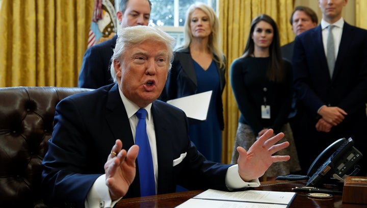 U.S. President Donald Trump speaks to reporters while signing executive orders at the White House in Washington January 24, 2017.