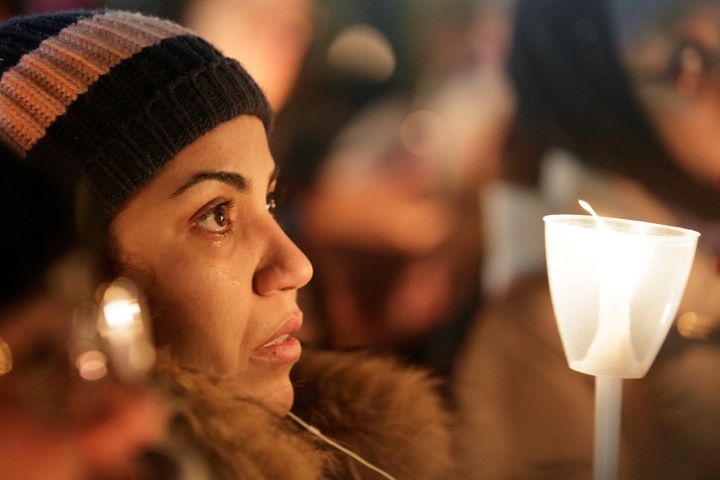 A woman becomes emotional during a vigil in support of the Muslim community in Montreal, Quebec, Jan. 30, 2017.