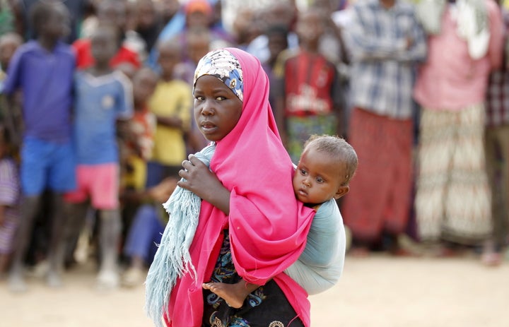 A Somali refugee child carries her sibling in Dadaab, the refugee camp near the Kenya-Somalia border, May 8, 2015. Dadaab is