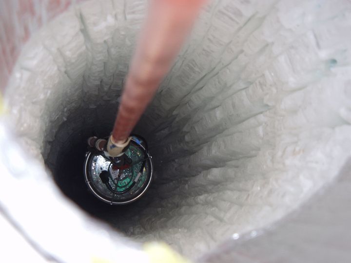 The Digital Optical Module for the IceCube South Pole Neutrino Observatory is lowered into the Antarctic ice.