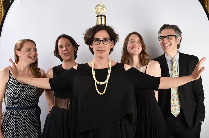 Sarah Koenig, center, poses with her Peabody award.