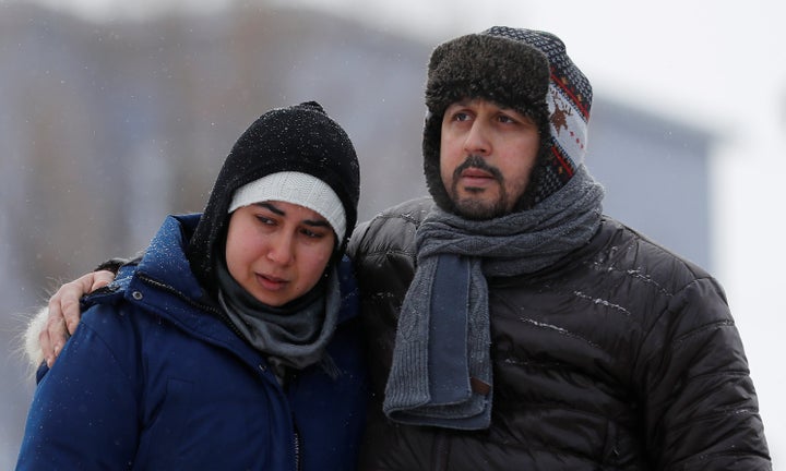 Azzedine Najd (R) and his wife Fadwa Achmaoui look at the memorial near the site of a fatal shooting at the Quebec Islamic Cultural Centre in Quebec City, Canada, Jan. 31, 2017.