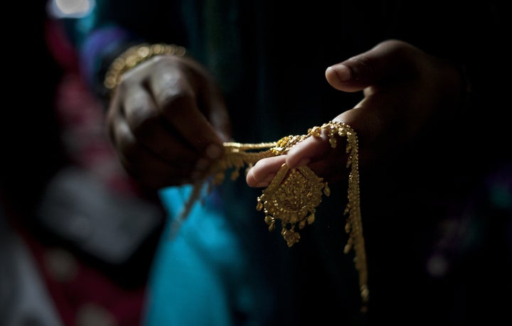 Gold wedding jewelry is laid out for 15 year old Nasoin Akhter on the day of her wedding to a 32 year old man, August 20, 2015 in Manikganj, Bangladesh.