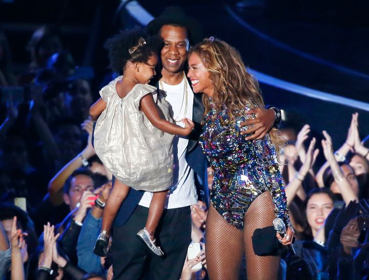 Beyonce smiles with Jay-Z and daughter Blue Ivy after accepting the Video Vanguard Award on stage during the 2014 MTV Video Music Awards in Inglewood, California August 24, 2014. REUTERS/Lucy Nicholson (UNITED STATES - Tags: ENTERTAINMENT) (MTV-SHOW)