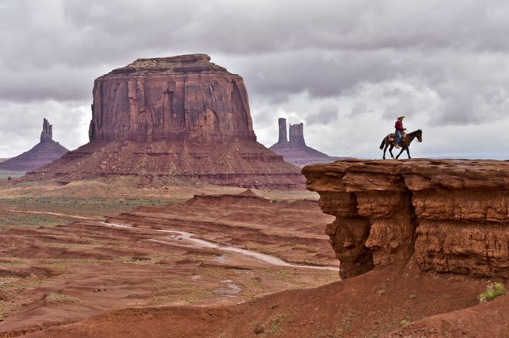 A Navajo man on a horse poses for tourists in front of Merrick Butte in Monument Valley Navajo Tribal Park, Utah, on May 16, 2015.