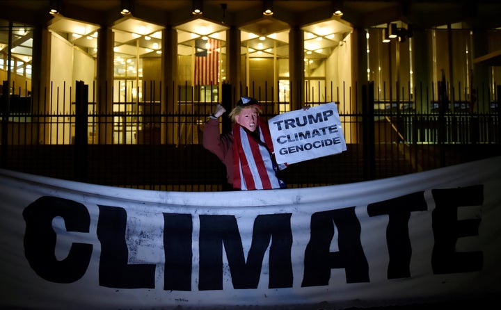 A man wearing a Trump mask protests during a demonstration against climate change outside the U.S. Embassy in London, Nov. 18, 2016.