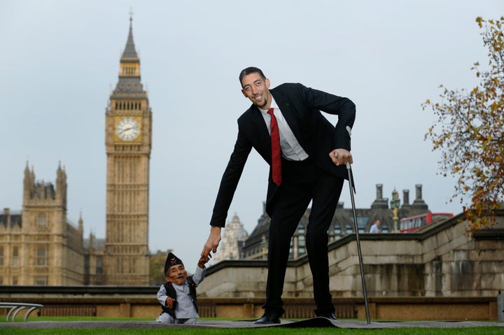 The world's shortest man Chandra Bahadur Dangi (54.6cm) greets the tallest living man Sultan Kosen (251cm).