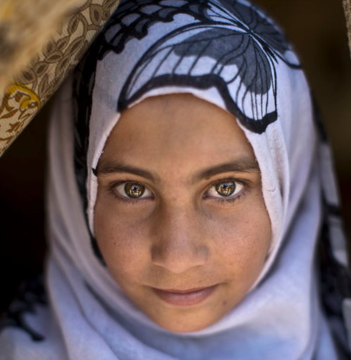 Syrian refugee Halima Ahmad in the doorway of her family's tent in the Jordan Valley, Jordan 