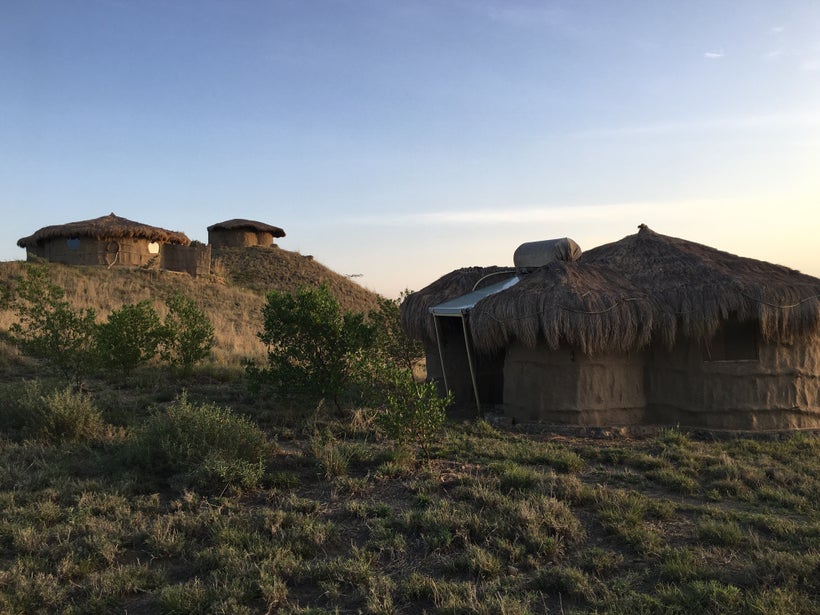 Traditional Maasai bomas are fitted with solar panels and water tanks