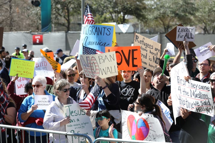 Demonstrators rallied against Trump's immigration policies outside Super Bowl events this week.