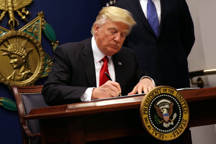 U.S. President Donald Trump signs an executive order to impose tighter vetting of travelers entering the United States, at the Pentagon in Washington, U.S., January 27, 2017.