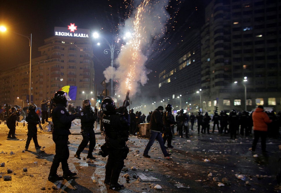 A Romanian police officer fires in the air at a demonstration in Bucharest, Romania, on Feb. 1, 2017.