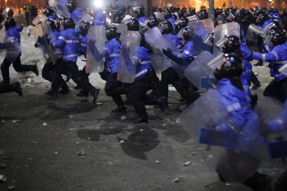 Romanian police charge at protesters in Bucharest, Romania, on Feb. 1, 2017.