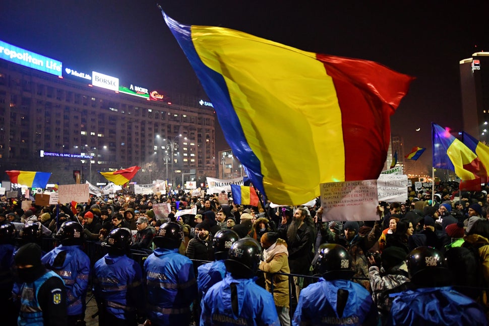 Romanian riot police stand guard as people demonstrate against decriminalizing corruption in Bucharest, Romania, on Feb. 1, 2
