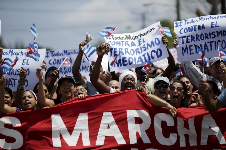 Government supporters shout against a regular march by the Ladies in White dissident group (not pictured), hours before President Barack Obama arrives for a historic visit in Havana, March 20, 2016.