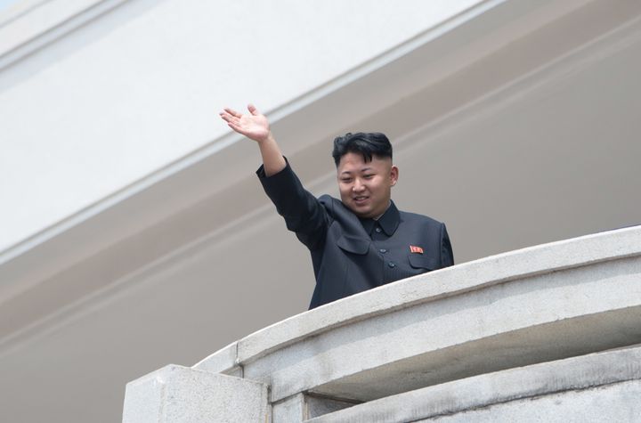 North Korean leader Kim Jong Un waves to the crowd during a military parade at Kim Il-Sung square marking the 60th anniversary of the Korean war armistice in Pyongyang on July 27, 2013.