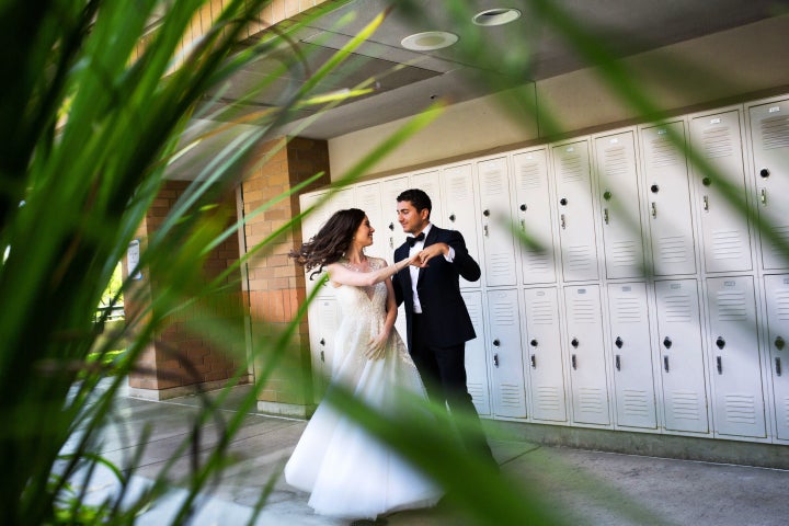 Posing for photos before the ceremony at our high school, where we first met.