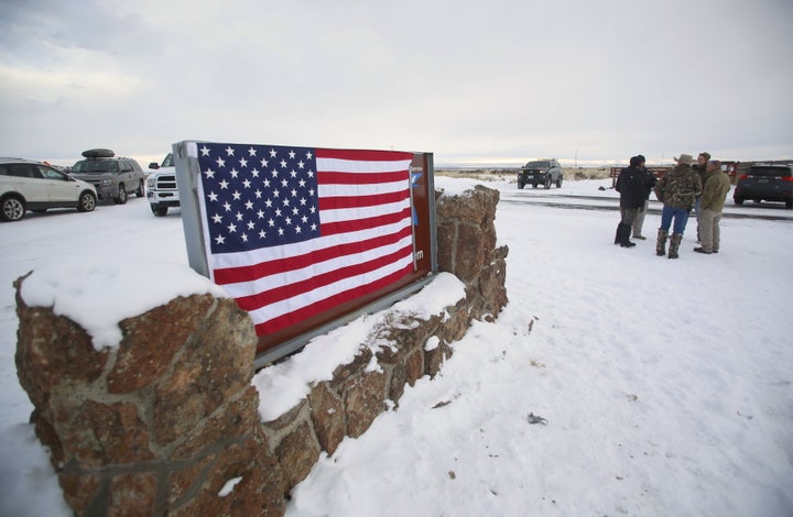 A U.S. flag covers a sign at the entrance of the Malheur National Wildlife Refuge near Burns, Oregon.