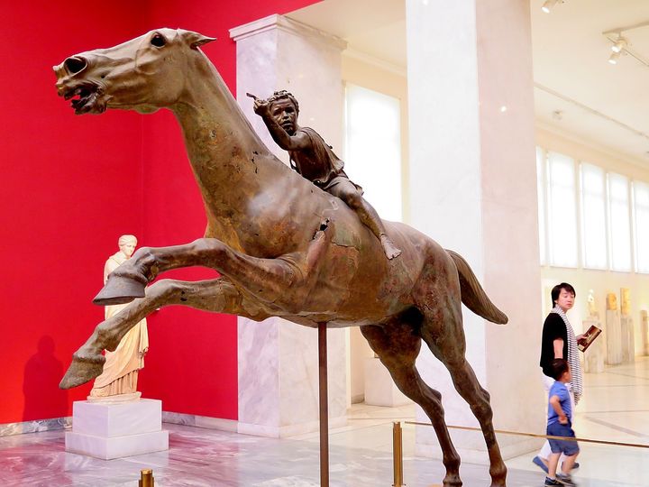 <p>Bronze statue of an African boy on a racing horse made during the time of Alexander the Great, at the National Archaeology Museum</p>