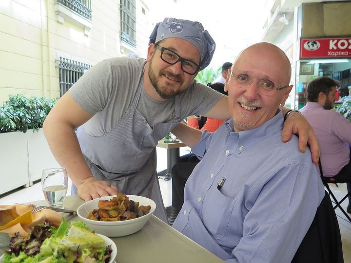 Athens with a Native: Constantine E. Cavoulacos, who volunteers with the city’s tourist office, with the owner of Panagiotis neighborhood eatery