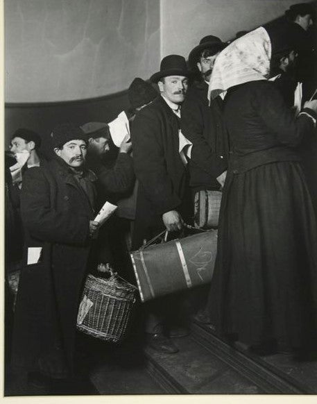 <strong>Climbing into America, Ellis Island, 1908. </strong>The man wearing a homburg and carrying a suitcase was among the m
