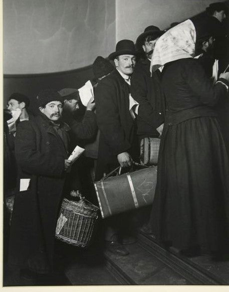 Climbing into America, Ellis Island, 1908. The man wearing a homburg and carrying a suitcase was among the middle class immigrants—as Donald Trump’s grandfather may have been. He was trained as a hairdresser but became a hotelier among other things once he got to the U.S.