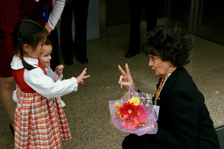 <p>Marilyn Carlson Nelson is greeted by children in Asia.</p>