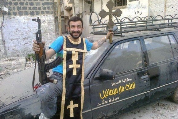 Free Syrian Army militant mocking sacked Christian symbols.