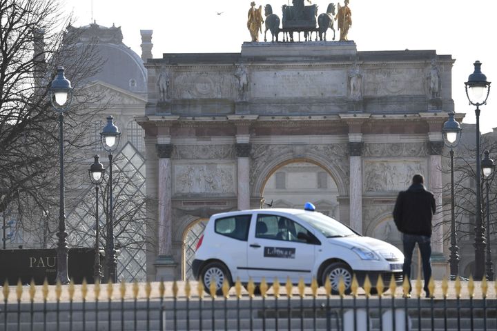 A man stands near the Louvre museum on February 3, 2017 in Paris after a soldier has shot and gravely injured a man who tried to attack him