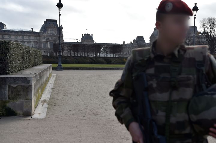 A French soldier stands guard near the Louvre.