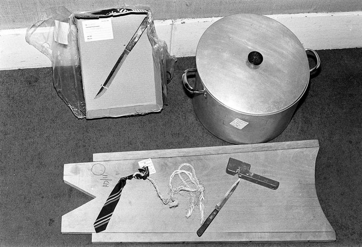 Exhibits on display at the Old Bailey. They include a copper pot in which Nilsen boiled victim's heads, a tie, a rope, knives and a knife sharpener and wooden board upon which he dissected remains