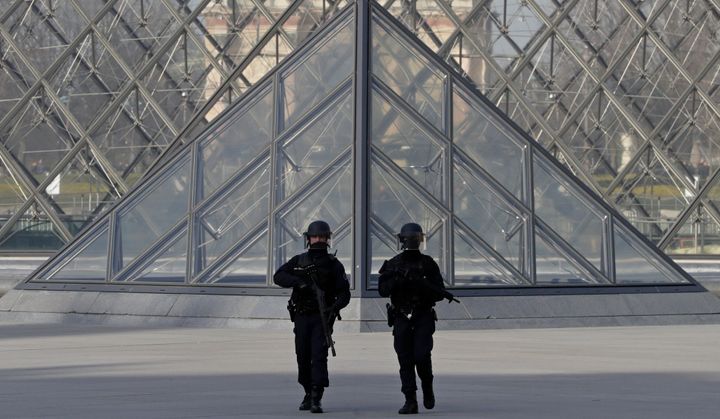 French police secure the site near the Louvre Pyramid in Paris, France following Friday's terror attack 