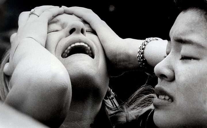 This photograph by George Kochaniec Jr. shows Columbine High School students Jessica Holliday (L) and Diwata Perez, moments after they fled the school during a violent rampage by two fellow students April 20, 1999. 