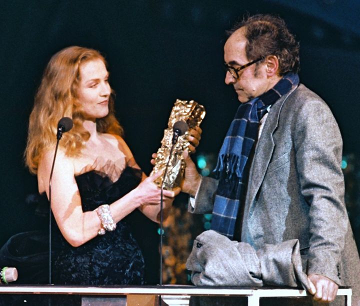 Isabelle Huppert presents a César Award to Godard in 1987.