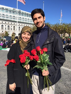 Hamideh and Amin at the annual commemoration of Ashura in Civic Square, San Francisco, where they pass out red roses symbolizing the sacrifice of Imam Husayn.