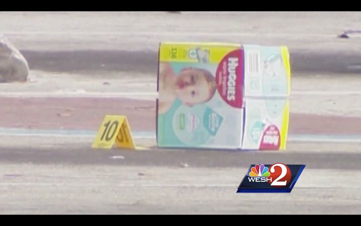 A box of diapers rests in the parking lot of a Florida Walmart after an alleged shoplifting incident turned deadly.