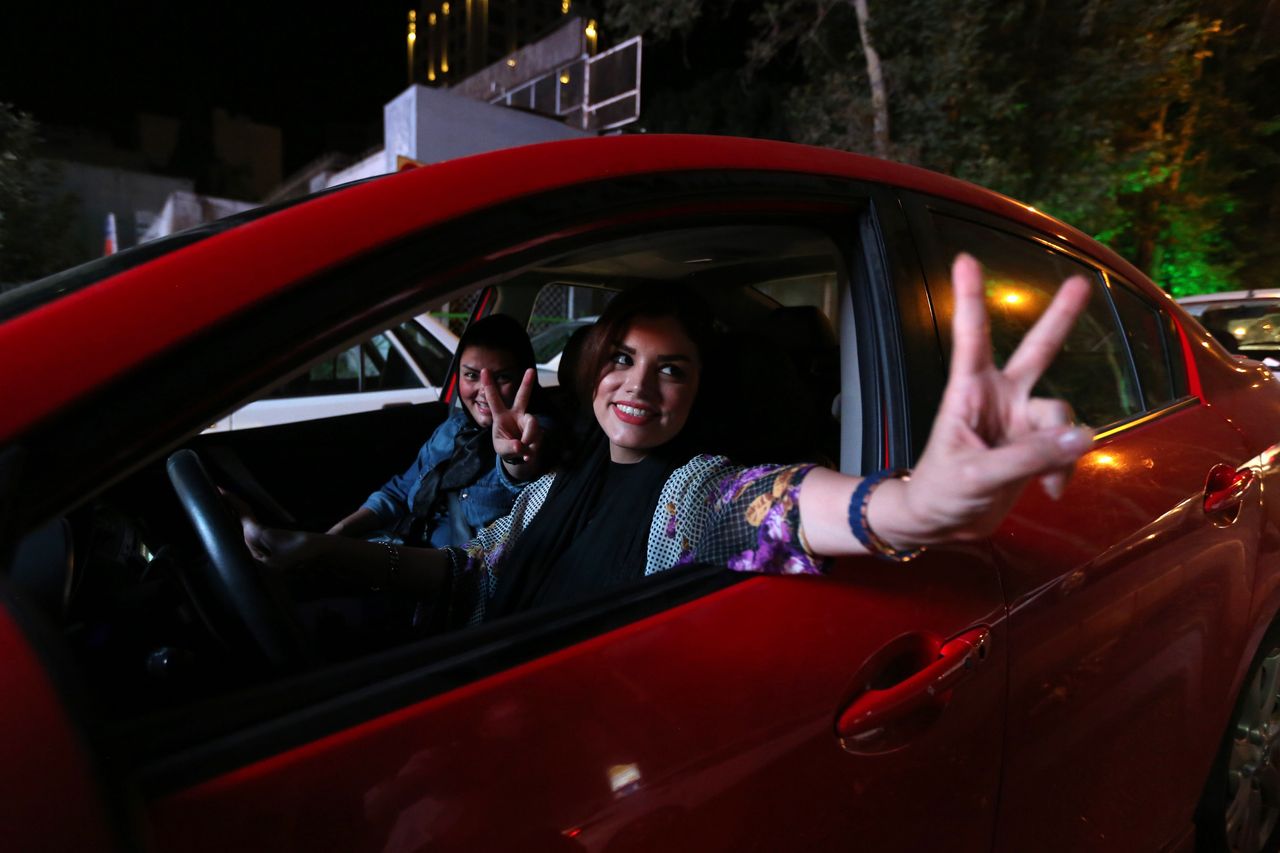 Iranian women flash the v sign for victory during celebration in northern Tehran on July 14, 2015, after Iran's nuclear negotiating team struck a deal with world powers in Vienna.