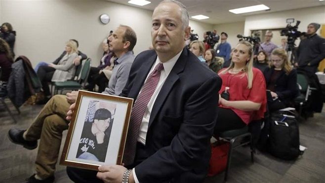Mark Lewis holds a photograph of his 27-year-old son who died from a heroin overdose at a conference on the opioid crisis in Salt Lake City. As an overdose epidemic grips the nation, governors are urging Congress and the Trump administration not to cut funding for treatment.