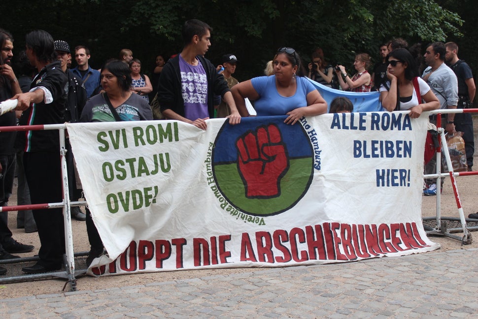 Roma migrants in Germany carry a sign that reads "ALL ROMA STAY HERE!" and "STOP THE DEPORTATIONS!" during a protes