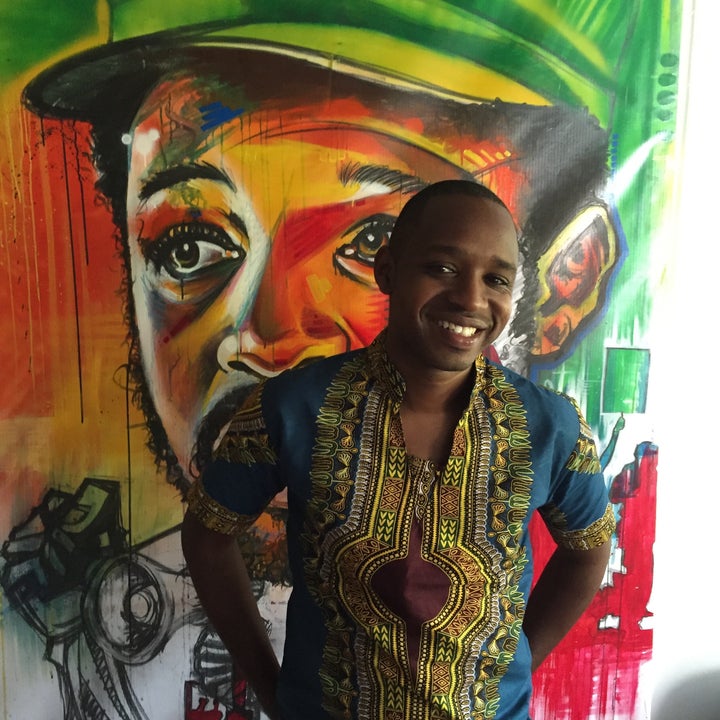Boniface Mwangi stands in front of a work of art in PAWA254, an art space founded in Nairobi’s Central Business District in 2