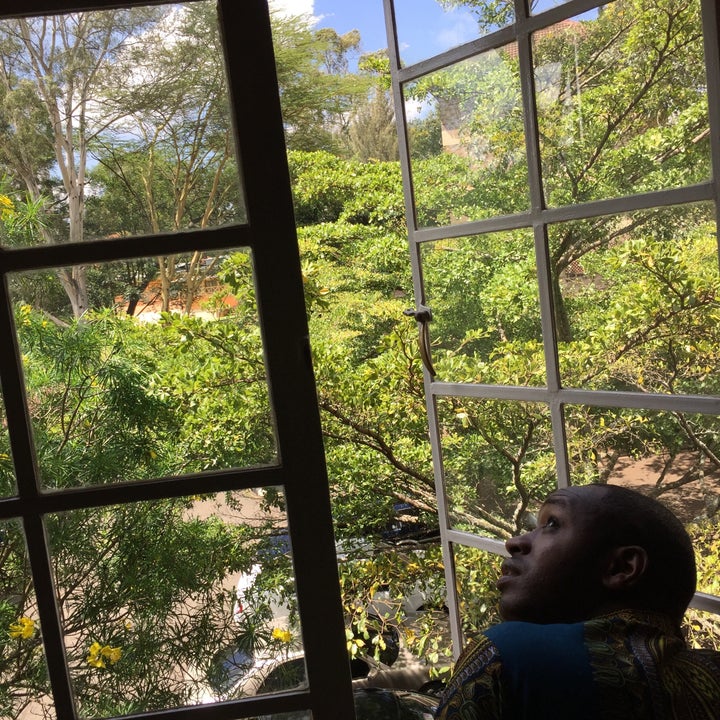 Boniface Mwangi looks out a window in his office at PAWA 254, an arts and activism space in Nairobi, Kenya.