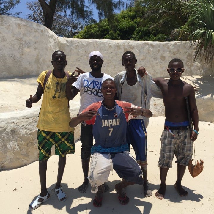 Five Sea Safari crew members pose for a group photo in Diani Beach, Kenya. 