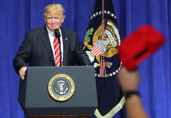 Donald Trump is welcomed as he speaks to commanders and coalition representatives during a visit to U.S. Central Command and U.S. Special Operations Command at MacDill Air Force Base in Tampa, Florida, U.S., February 6, 2017. REUTERS/Carlos Barria