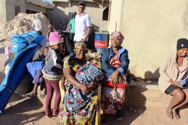 The morning after outgoing President Jammeh left Gambia, this family of women and children await the bus to Banjul.