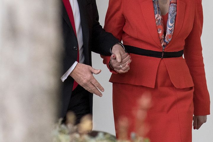 May was photographed holding Trump's hands while walking down the White House Colonnade in January 