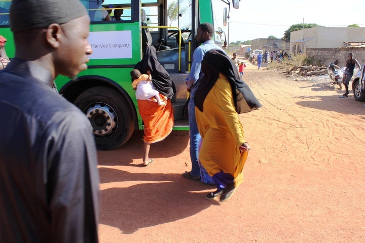 Buses dispatched by the Gambian government arrive at the refugee camp in Karang, Senegal; 70 percent of the returnees were women and children, according to HelpGambia volunteers.